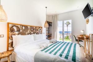 a bedroom with a bed with a large wooden headboard at Outsite Ibiza - Work, Connect, Explore in Es Cana