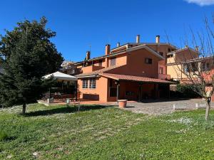 a large house with a yard in front of it at A casa nostra in Formello