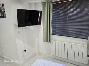 a white room with a tv and a window at Best room in Birmingham