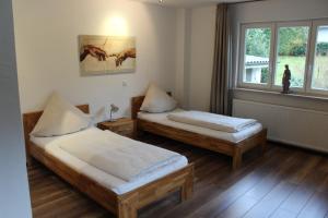 a room with two beds and a window at Hotel Ovelgönner Hof in Buxtehude