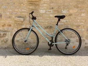 a bike parked in front of a brick wall at Le Verger de la Tannerie in Chesley