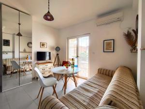 a living room with a couch and a table at Apartments Skipper bay Baosici in Baošići