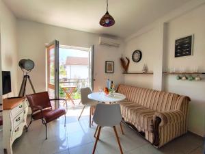 a living room with a couch and a table at Apartments Skipper bay Baosici in Baošići +17 photos