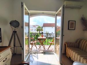 a living room with a sliding glass door leading to a patio at Apartments Skipper bay Baosici in Baošići