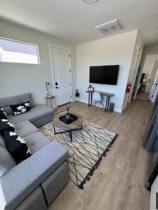 a living room with a couch and a tv at New Casita by Zion National Park and Saint George in Hurricane