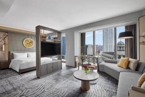 a hotel room with a bed and a large window at Conrad Shanghai in Shanghai