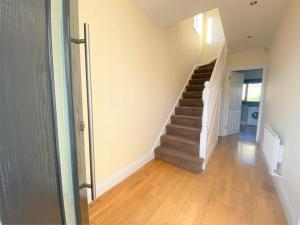 a hallway with a staircase in a house at Dublin Cosy Home in Dublin