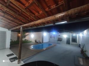 a large patio with a swimming pool at night at Casa Oliveira in Montes Claros +6 photos