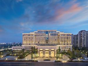 a large white building with a rainbow in the sky at Doubletree By Hilton Quzhou in Quzhou