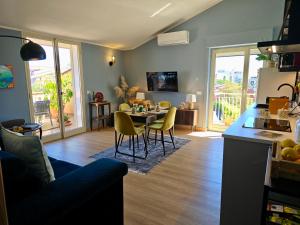 a kitchen and living room with a table and chairs at SuiteLina in Giardini Naxos