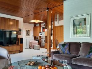 a living room with a couch and a tv at Hill Star in Mönchengladbach