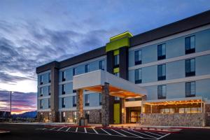 a building with a parking lot in front of it at Home2 Suites By Hilton Redding in Redding