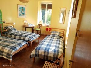 a room with two beds and a table at Moulin de la Varenne in Saint-Saturnin
