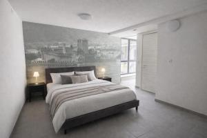 a bedroom with a large bed with a painting on the wall at Tibetan BB in Bellinzona