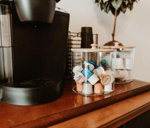 a counter with a container filled with small wooden pins at Strassner Suites - Imy Suite in Hermann