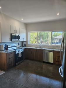 a large kitchen with wooden cabinets and a large window at Fernie Alpine Retreat in Fernie