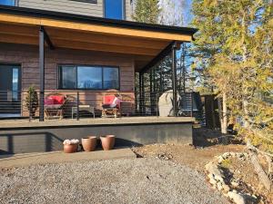 a porch of a house with two chairs and a table at Fernie Alpine Retreat in Fernie