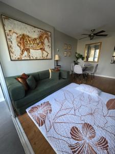 a bedroom with a bed and a green couch at Charming Abode Downtown Vancouver in Vancouver
