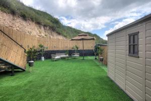 a backyard with a grass yard with a table and a fence at אחוזת בין ההרים צפת in Safed +10 photos