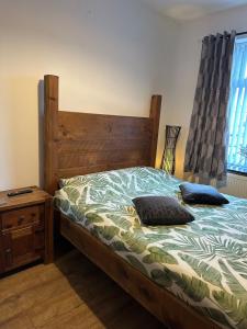a bedroom with a bed with two pillows on it at Snuggle Inn Burnley in Burnley +20 photos