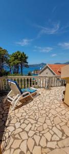 a patio with a lounge chair and a pool at Apartmani Fico II in Sveti Stefan
