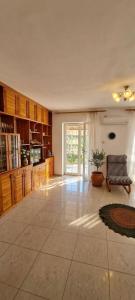a large room with a large kitchen with a window at Apartmani Fico II in Sveti Stefan