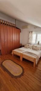 a large bedroom with two beds and a rug at Apartmani Fico II in Sveti Stefan