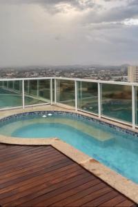 a swimming pool on the roof of a building at Hellix Flat Itaboraí in Itaboraí
