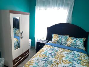 a bedroom with a bed with blue walls and a window at Blue Paradise in Coxen Hole +71 photos