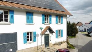 a house with solar panels on the roof at Ferienwohnung Altes Pfarrhaus in Blumberg +7 photos