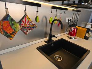 a kitchen counter with a sink and some cooking utensils at SuiteLina in Giardini Naxos +33 photos