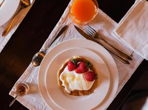 a dessert with strawberries on a plate on a table at Casa Vecchia Bed&Breakfast in Bossolasco +54 photos