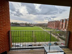 a balcony with a view of a field and buildings at Stunning 2Bedrooms, 2Baths, Balcony, Parking in Colindale