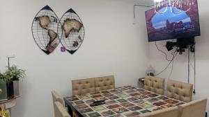a dining room table with two chairs and a picture on the wall at Duplex parque in Santiago del Estero