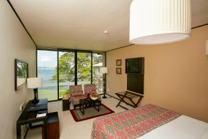 a bedroom with a bed and a view of the ocean at Ekho Safari Tissa in Tissamaharama