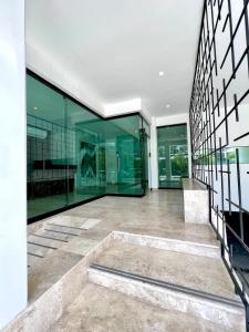 a large building with glass windows and a staircase at Luxury Apartment top location! in Playa del Carmen