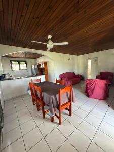 a living room with a table and chairs and a couch at Le Désircaraïbe in Tartane +31 photos
