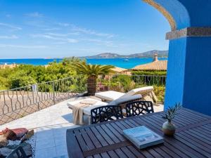 a patio with a table and chairs and the ocean at Villa Azzurra in Cannigione