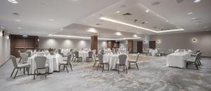 a banquet hall with white tables and chairs at Doubletree By Hilton Plovdiv Center in Plovdiv