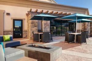 a patio with tables and chairs and umbrellas at Hampton Inn & Suites Marina in Marina