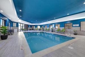 a large pool in a hotel with blue ceilings at Hampton Inn & Suites Marina in Marina