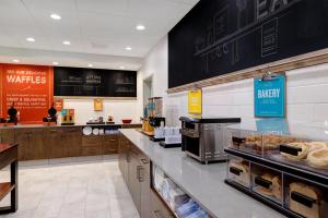 a bakery with a counter with pastries on it at Hampton Inn & Suites Marina in Marina