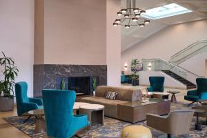 a lobby with a couch and chairs and a fireplace at Doubletree by Hilton Buena Park in Buena Park