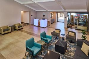 a lobby with chairs and tables in a building at Doubletree by Hilton Buena Park in Buena Park +70 photos