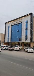a large building with cars parked in a parking lot at راحتي هنا in Riyadh