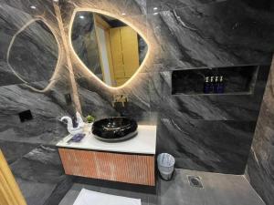 a bathroom with a sink and a mirror at La Maison Royale Hotel in Lahore