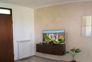 a living room with a tv on a wall at A casa di Any in Cascina