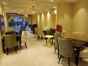 a restaurant with tables and chairs in a room at La Maison Royale Hotel in Lahore +28 photos