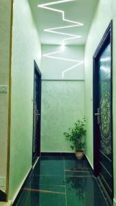 a hallway with two doors and a potted plant at LH Appart 1 bel appartement cosy, vu sur montagnes, proche du lac de Bin el Ouidane et de cascades d'Ouzoud in Afourer