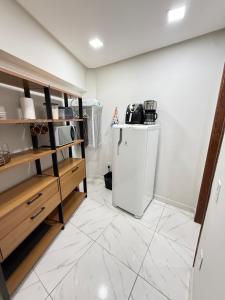 a kitchen with a small refrigerator and a tiled floor at Centro de Vitoria in Vitória